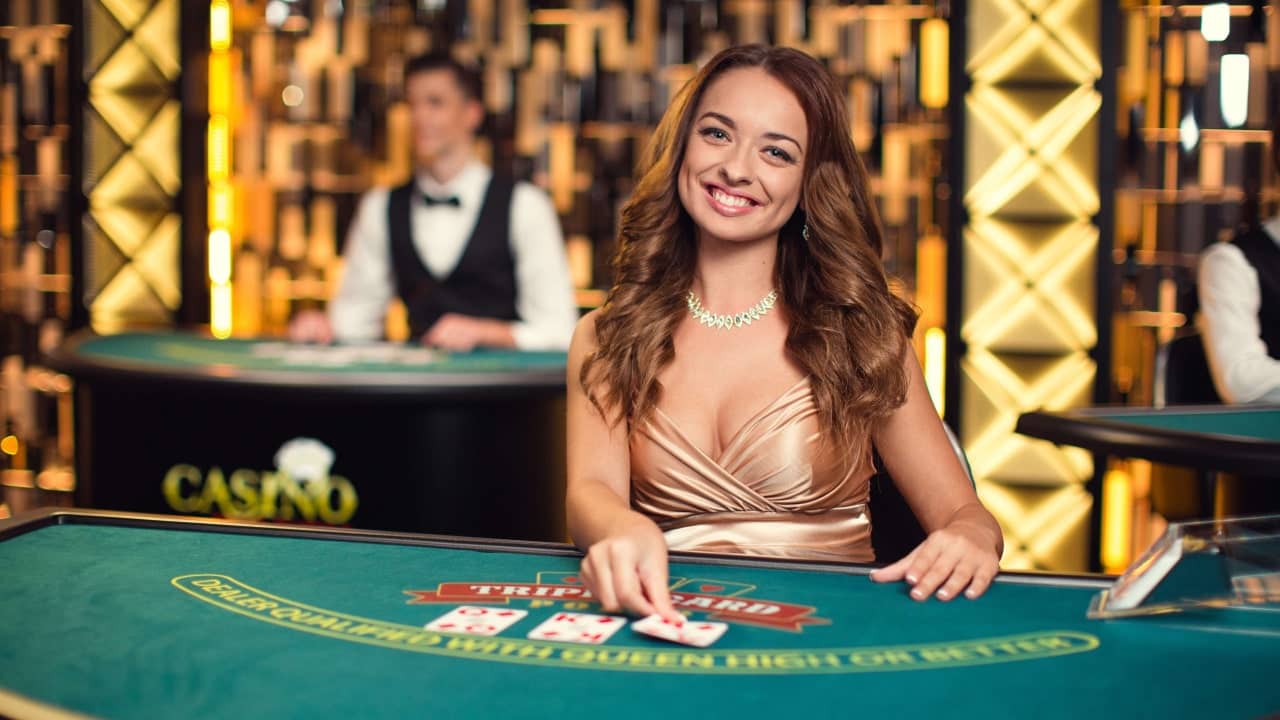 Smiling live casino female live dealer and dealing cards