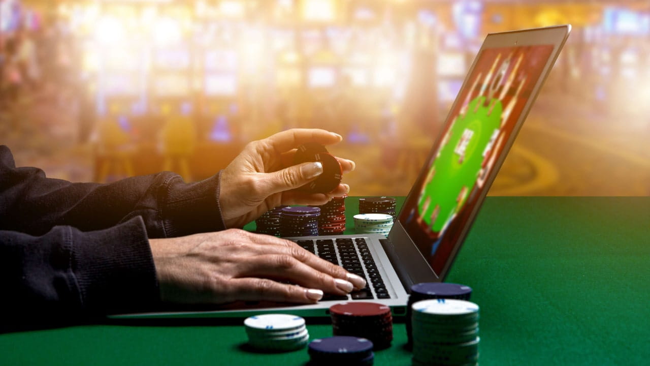 Man playing online casino games on laptop